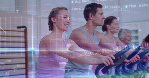 Group spinning class pedaling together on indoor bikes with fitness analytics overlay