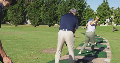 Seniors Engaging in Golf Practice Outdoors on Sunny Day - Download Free Stock Images Pikwizard.com