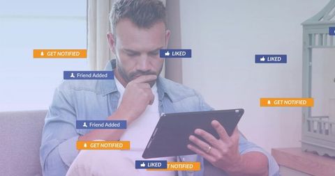 Man Relaxing on Couch Engaging with Social Media on Tablet