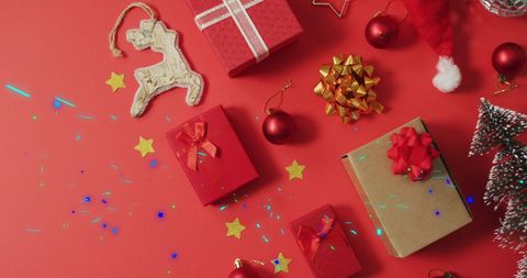 Festive Christmas Decorations and Glowing Light Trails on Red Background - Download Free Stock Images Pikwizard.com