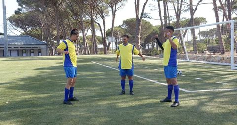 Soccer Players Warming Up on Field in Yellow Jerseys