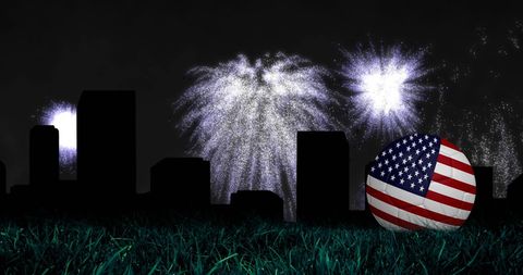 Fireworks Above City and Soccer Ball Adorned with USA Flag