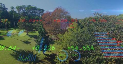 Drone capturing aerial park landscape with ar hud data overlay over trees and lawn