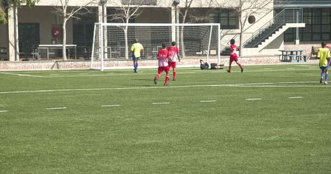 Youth soccer players competing on field focuses on team strategy