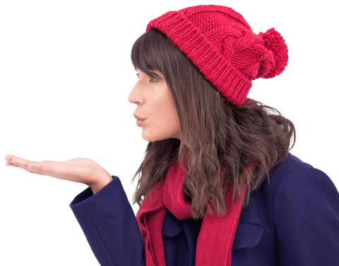 Brunette woman in red beanie and scarf blowing kiss on transparent background