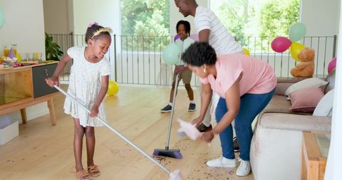 Family Cleaning Up After Household Celebration