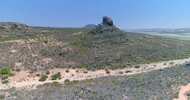 Aerial View of Rocky Hill and Arid Landscape Under Clear Skies - Download Free Stock Images Pikwizard.com