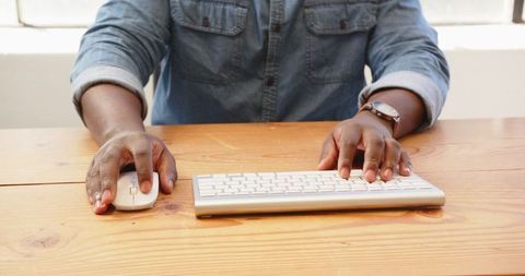 Close-Up of Hands Typing on Wireless Keyboard on Wooden Desk - Download Free Stock Images Pikwizard.com