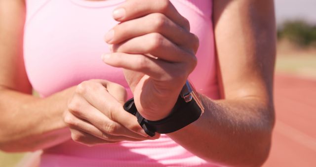 Woman Adjusting Smartwatch While Exercising Outdoors - Download Free Stock Images Pikwizard.com