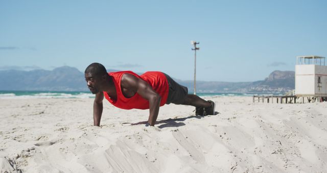 Man Performing Push-Ups on Beach for Outdoor Workout - Download Free Stock Images Pikwizard.com