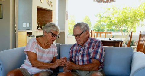 Senior Couple Engaged in Conversation on Couch at Home - Download Free Stock Images Pikwizard.com
