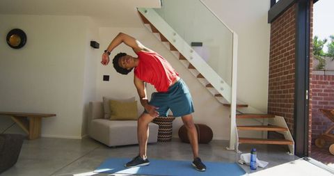 African American Man Stretching during Home Workout