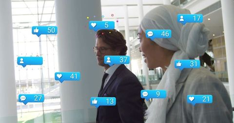 Business colleagues walking and chatting in modern office atrium with social media overlays