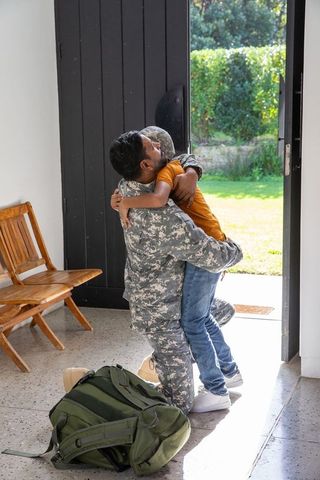 Emotional homecoming embrace between military father and son
