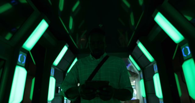 Futuristic Tunnel with Green Neon Lighting and Man Holding Device - Download Free Stock Images Pikwizard.com