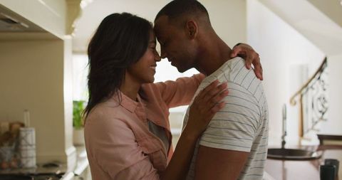 Happy Couple Enjoying Tender Moments in Kitchen