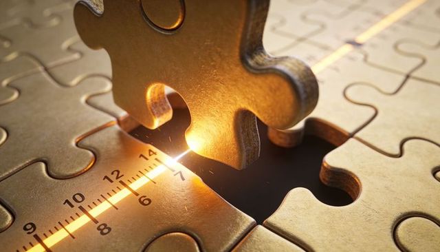 Golden jigsaw piece aligning with illuminated laser scale, precision, engineering concept