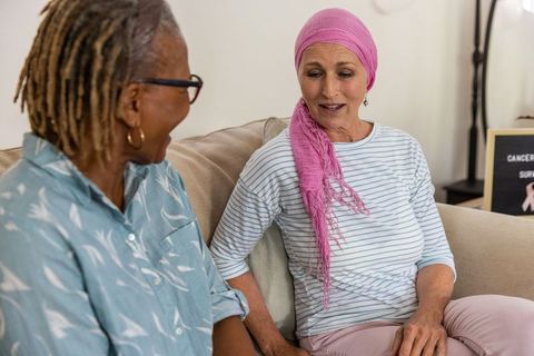 Two senior women sharing supportive conversation at home