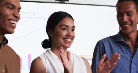 Joyful Multiracial Team Celebrating Success in Office Meeting