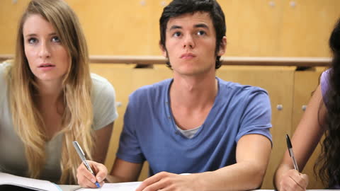 Focused Students Taking Notes in Classroom Lecture