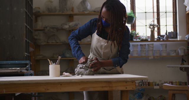 Focused Female Artisan Sculpts Clay in Creative Studio - Download Free Stock Images Pikwizard.com