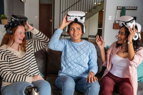 Women Enjoying Virtual Reality Experience in Cozy Living Space