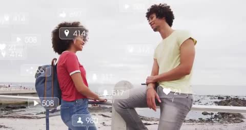 Two People Engaging with Social Media Overlays by Seaside