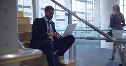 Businessman Working on Stairs in Contemporary Office Environment - Download Free Stock Images Pikwizard.com