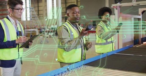 Industrial workers scanning inventory on conveyor belt