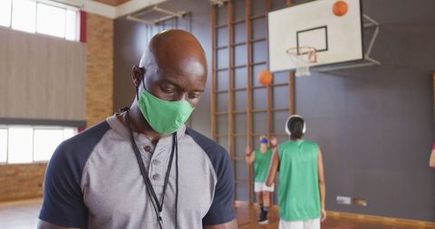 Basketball Coach Immersed in Training During Pandemic Indoors - Download Free Stock Images Pikwizard.com