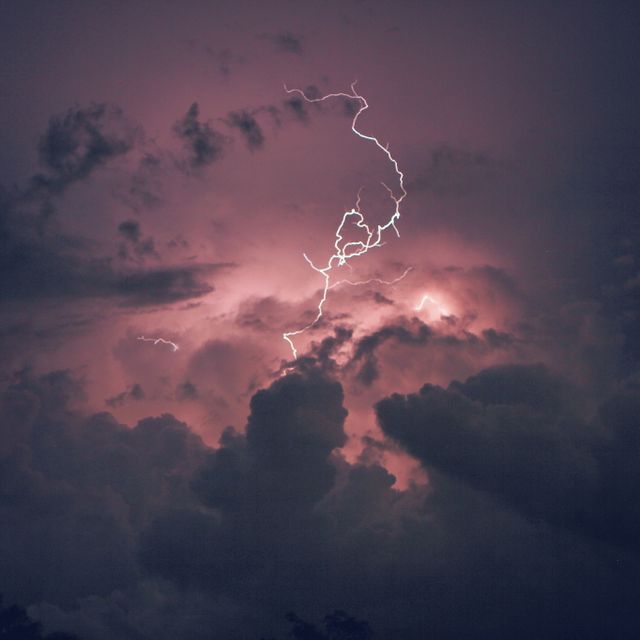 This vivid and dramatic image showcases lightning bolts illuminating dark thunderstorm clouds at night, creating an intense and powerful atmosphere. It is ideal for use in weather-related publications, educational materials about natural phenomena, environmental awareness campaigns, or as a dramatic background for websites and social media posts focusing on power, energy, and nature’s forces.