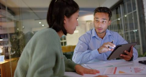 Diverse Colleagues Collaborating Late in Casual Office Meeting