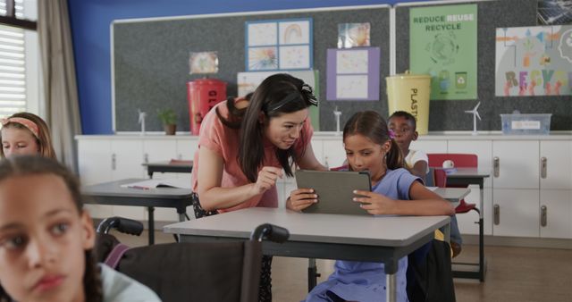 Teacher Helping Student with Tablet in Eco-friendly Classroom - Download Free Stock Images Pikwizard.com