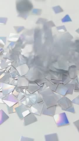 Falling iridescent shards scattering rainbow light across white platform | Vertical loop