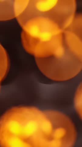 Vertical Abstract Golden Bokeh Loop Pulsing Circles Drifting Resizing in Dark Void