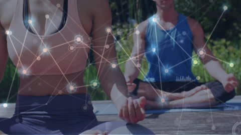 Caucasian Couple Meditating with Digital Network Overlay