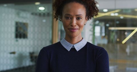Confident Biracial Businesswoman Smiling in Modern Office Environment