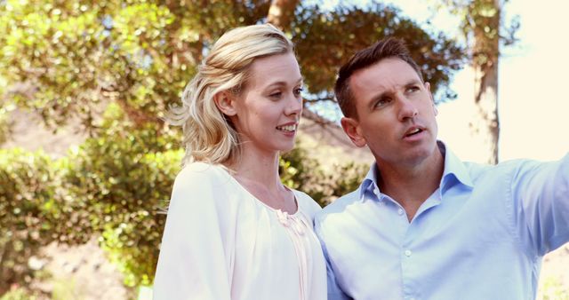 Couple Enjoying Nature Walk Pointing at Scenic View - Download Free Stock Images Pikwizard.com