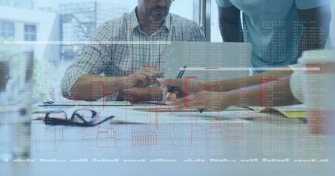 Team collaborating on data analysis and interactive dashboards at modern urban office table