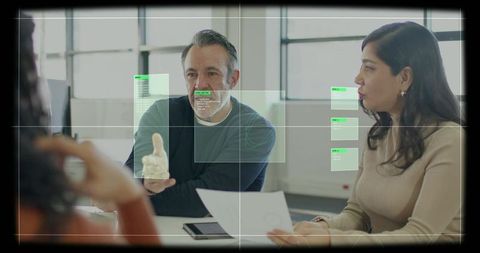 Pointing man and woman collaborating over document with augmented reality hud in office