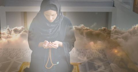 Asian Woman in Hijab Praying with Spiritual Serenity - Download Free Stock Images Pikwizard.com