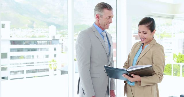 Smiling Business Colleagues Sharing Documents in Office - Download Free Stock Images Pikwizard.com