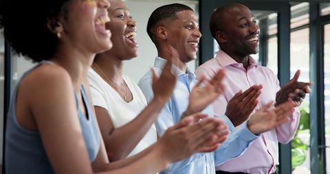 Diverse Professionals Applauding Success in Modern Office