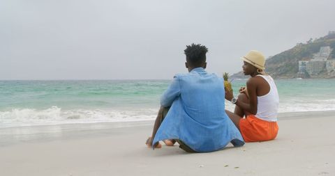Couple Enjoying Tropical Pineapple Drinks on Beach