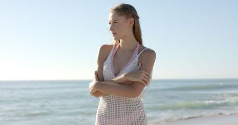 Tranquil moment of young woman on sunny beach in slow motion