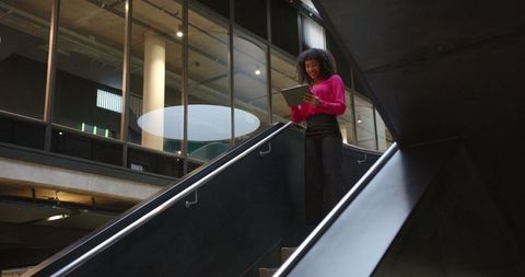 Confident Professional Woman Using Tablet in Office Atrium
