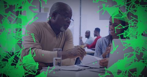 Mentor offering guidance in innovative workspace