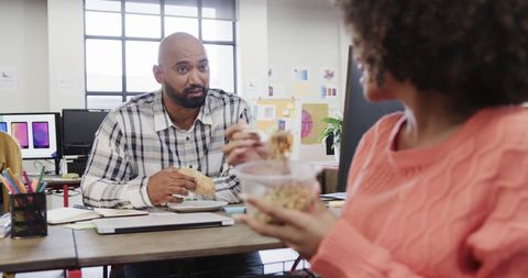 Colleagues enjoying lunch break in modern office