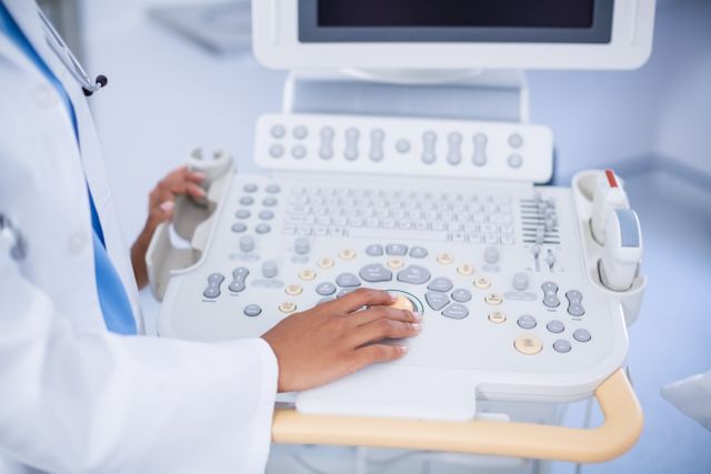 Doctor operating ultrasound machine in hospital. Ideal for use in medical articles, healthcare websites, hospital brochures, and educational materials about medical diagnostics and technology.