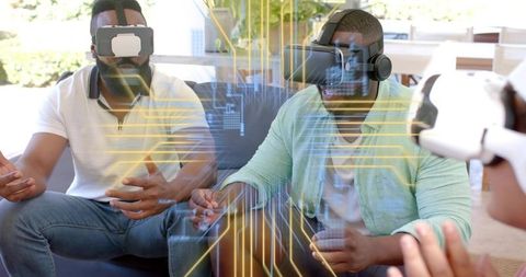 Friends Wearing VR Headsets Playing Multiplayer Game with Futuristic Holographic Interface